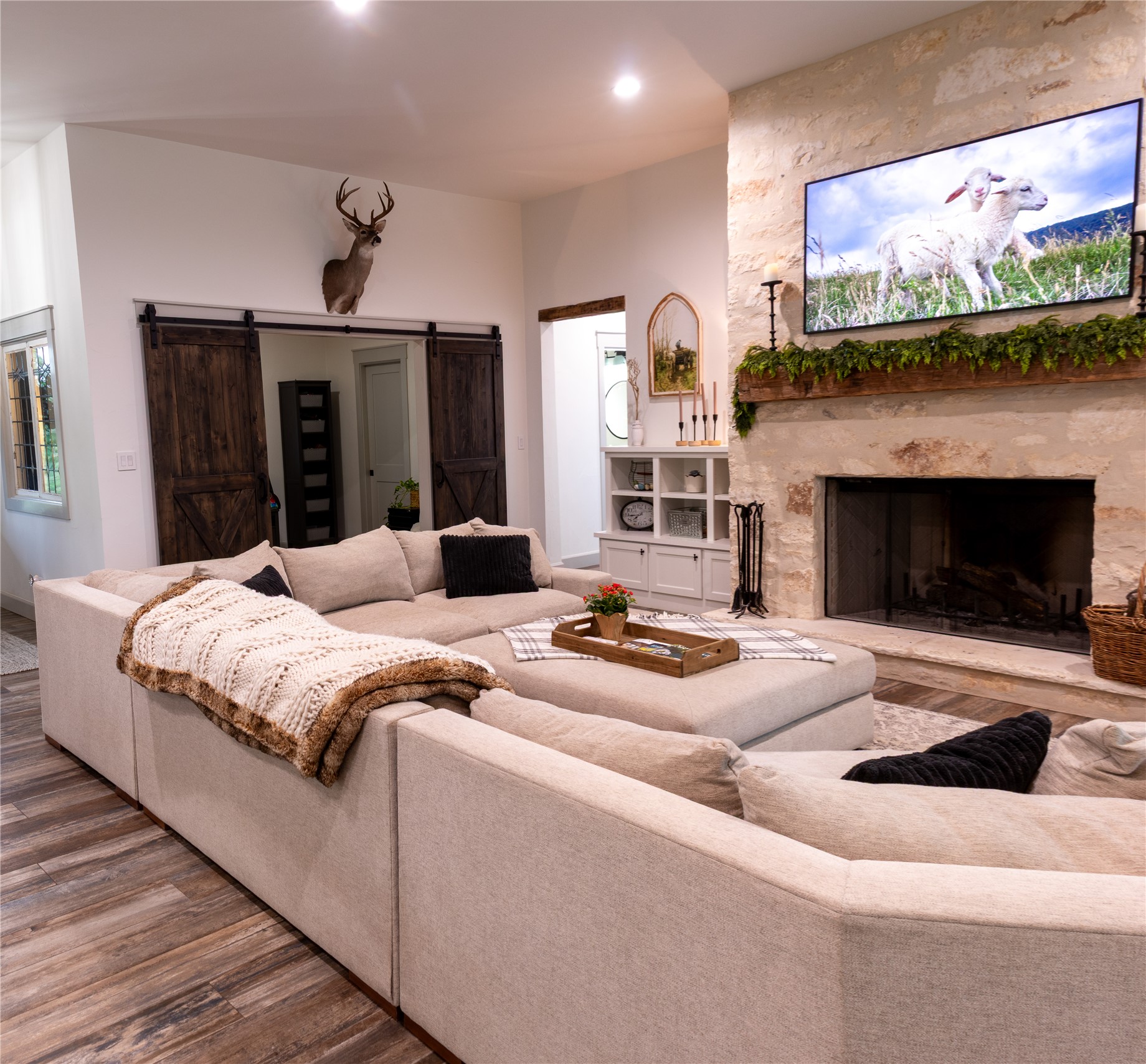 272 Slate Rock Road Fredericksburg, TX 78624 - Photo 15 of 32 A spacious sectional defines this warm living area, anchored by a TX limestone fireplace with a rustic wood mantel. Office #1 off to the side.