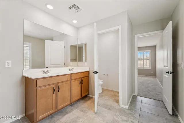 a spacious bathroom with a granite countertop sink mirror and a
