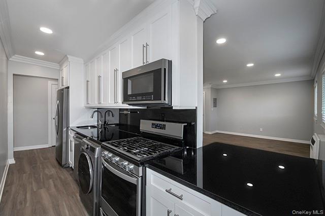 407 East Main Street, Unit 4075B Bay Shore, NY 11706 - Photo 2 of 8 a kitchen with stainless steel appliances granite countertop a stove a refrigerator and a microwave