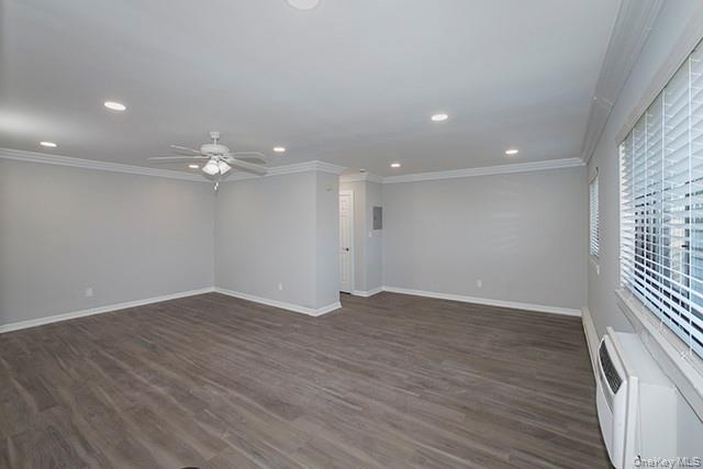 407 East Main Street, Unit 4075B Bay Shore, NY 11706 - Photo 6 of 8 an empty room with wooden floor and ceiling fan
