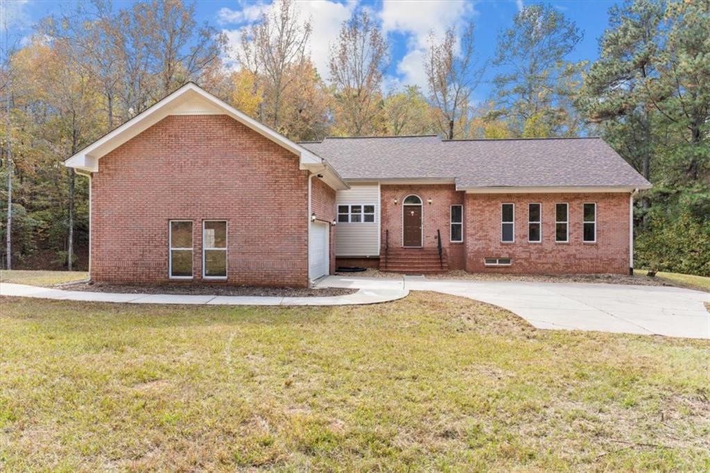 5615 Fouts Mill Road Douglasville, GA 30135 - Photo 1 of 1 a front view of a house with a yard