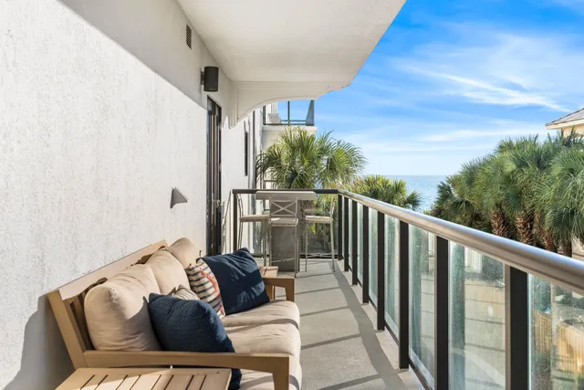 a dining hall with stainless steel appliances kitchen island granite countertop a table chairs and a refrigerator