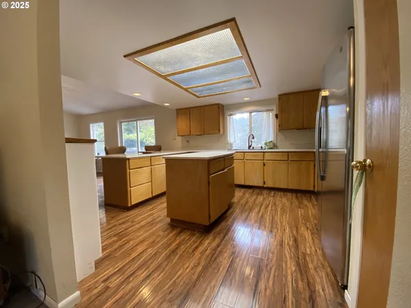 a kitchen with a cabinets and wooden floor