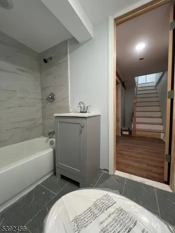 a bathroom with a bathtub and a sink