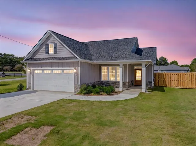 a front view of a house with garden
