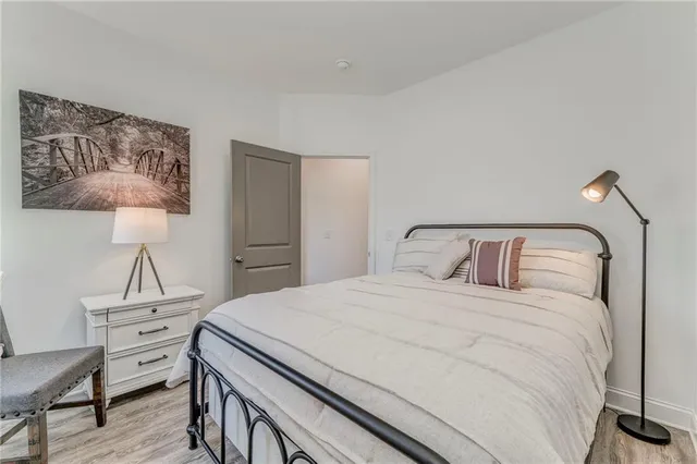 a bedroom with a bed and a lamp on table