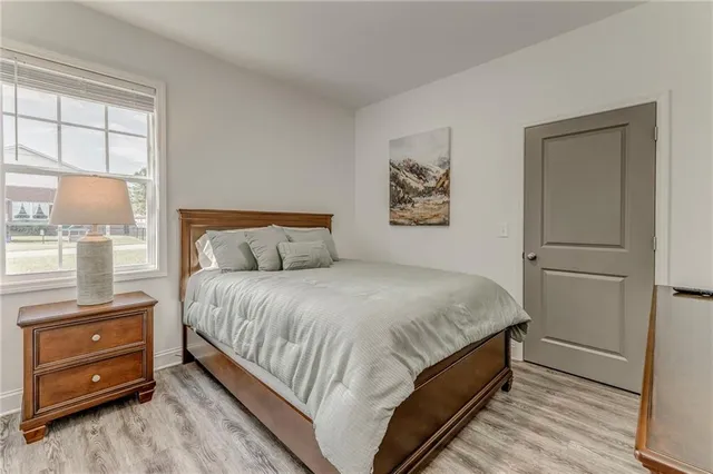 a bedroom with a bed and a night stand