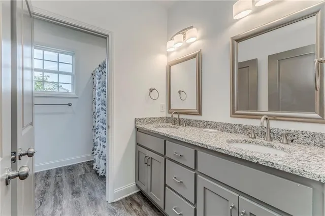 a bathroom with a granite countertop sink and a mirror
