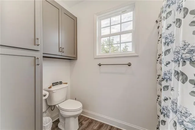 a white toilet sitting next to a window