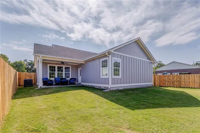a view of a house with a yard and sitting area