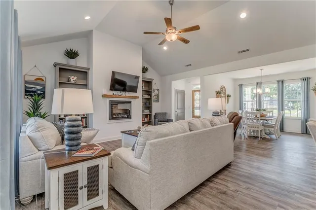 a living room with furniture fireplace and flat screen tv