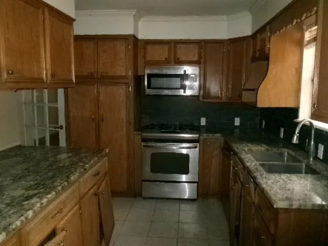 a kitchen with a sink stove and microwave