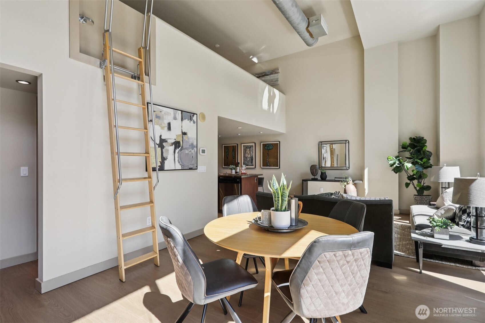 900 Lenora Street, Unit W106 Seattle, WA 98121 - Photo 12 of 40 a view of a dining room with furniture and chandelier