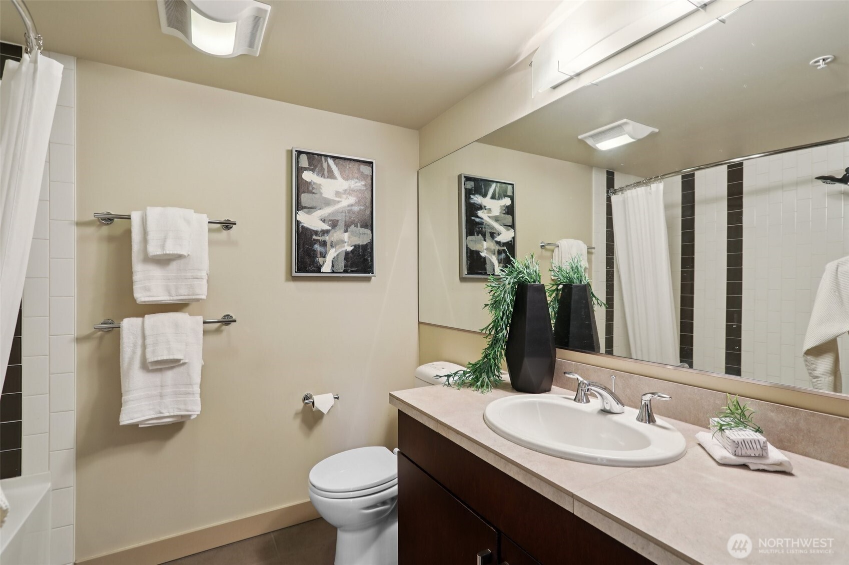 900 Lenora Street, Unit W106 Seattle, WA 98121 - Photo 15 of 40 a bathroom with a granite countertop sink mirror vanity and toilet