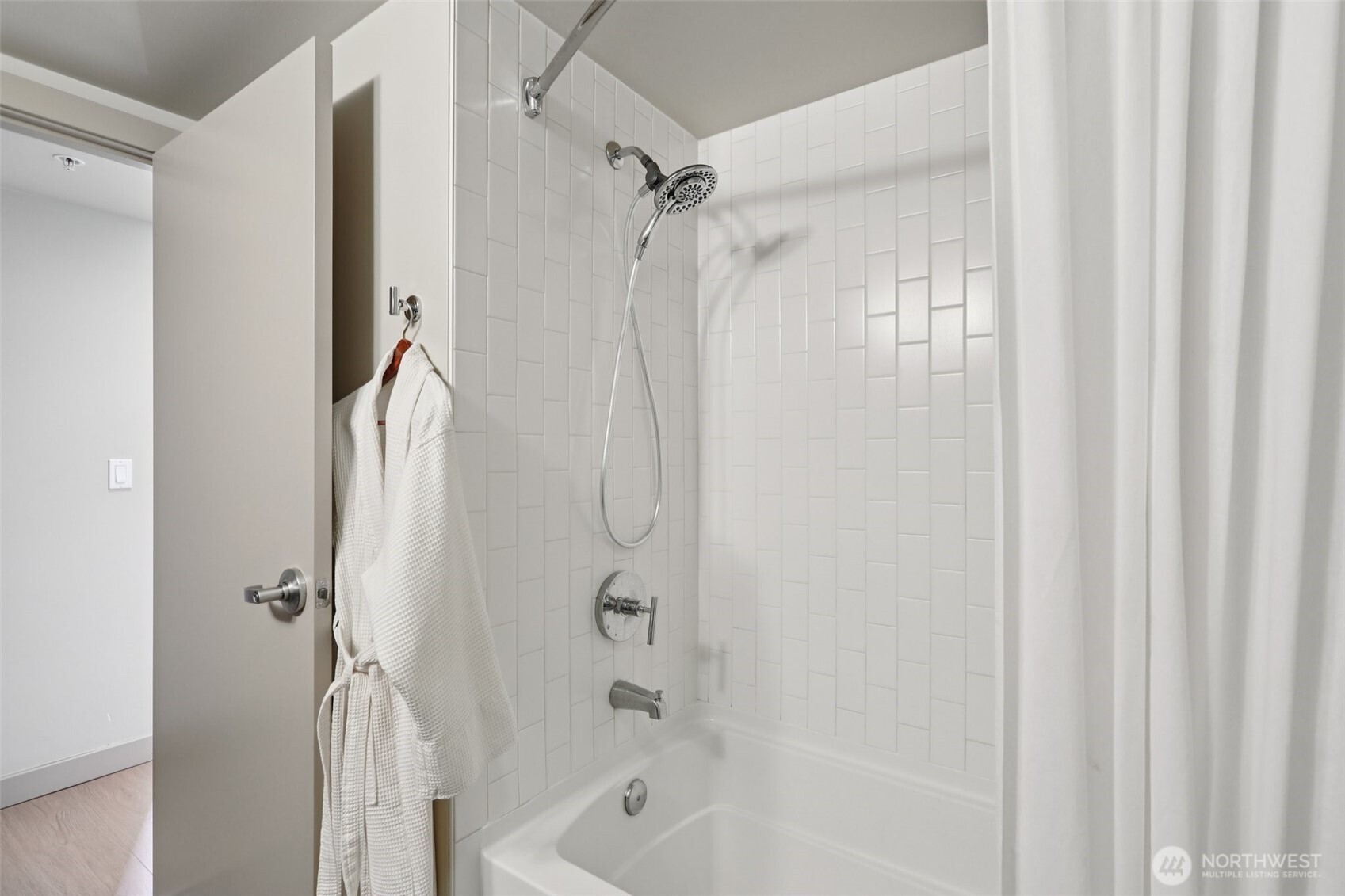 900 Lenora Street, Unit W106 Seattle, WA 98121 - Photo 16 of 40 a bathroom with a shower and a bath tub