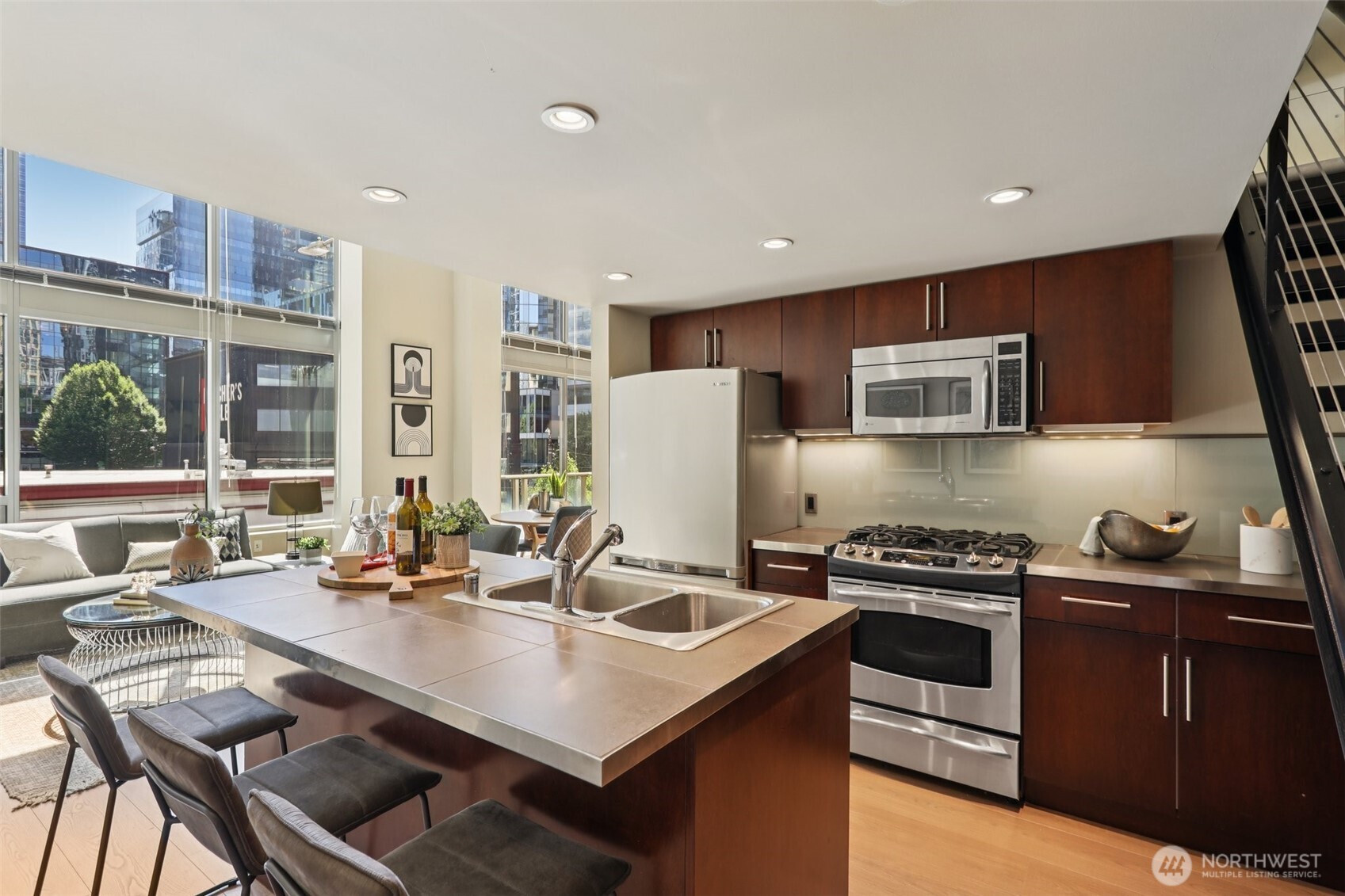 900 Lenora Street, Unit W106 Seattle, WA 98121 - Photo 2 of 40 a kitchen with stainless steel appliances a stove a sink a microwave a refrigerator and cabinets