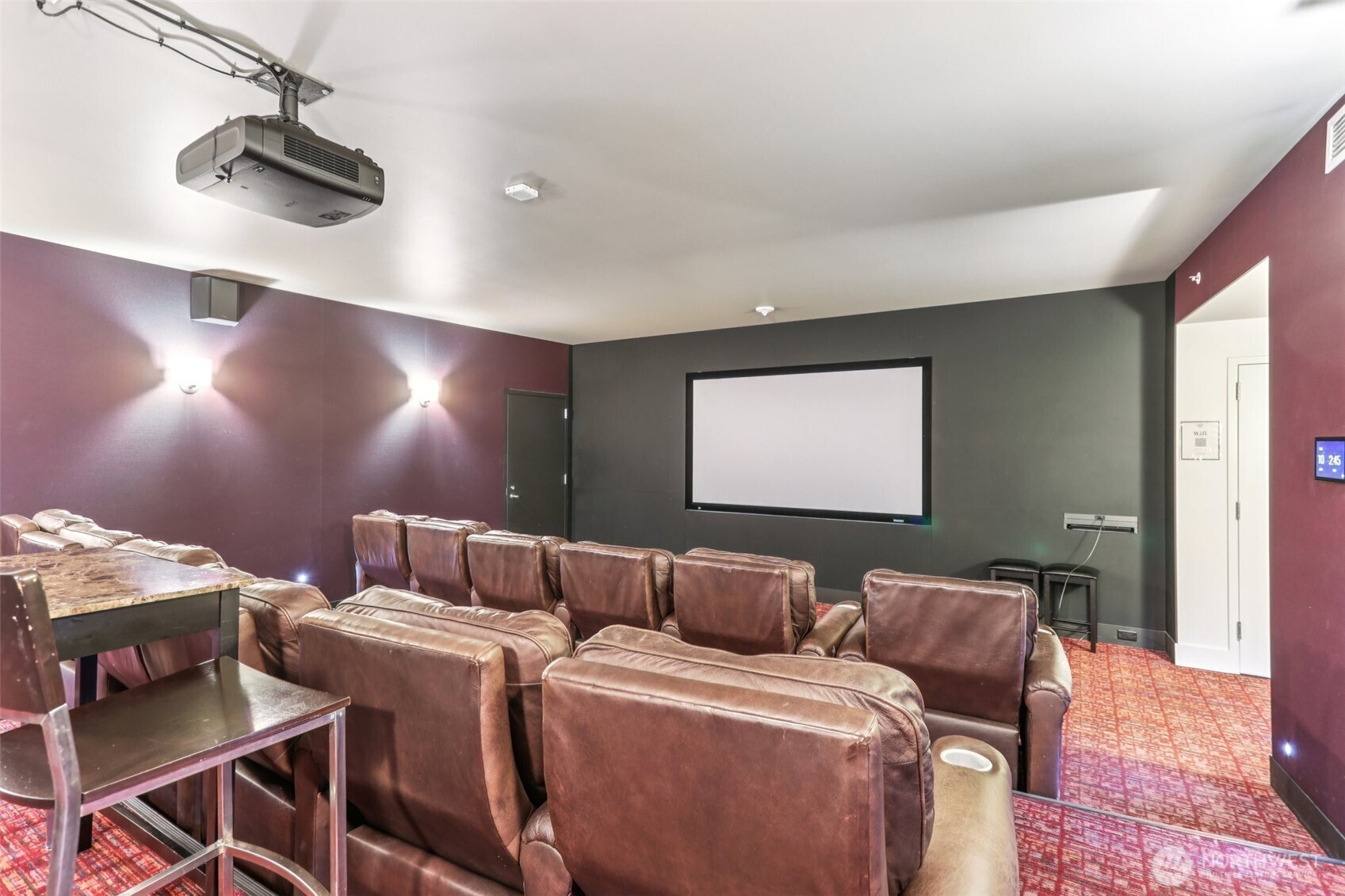 900 Lenora Street, Unit W106 Seattle, WA 98121 - Photo 26 of 40 a media room with lots of chairs and a projector screen