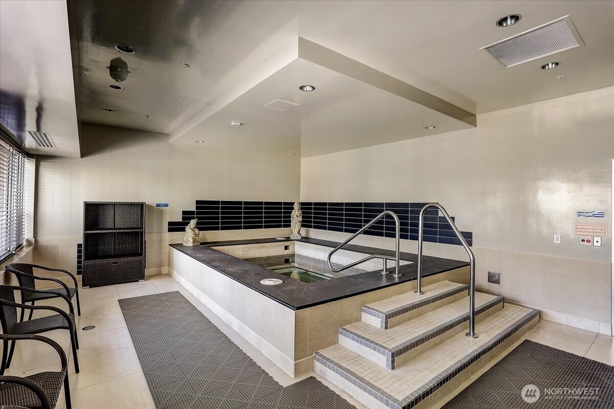 900 Lenora Street, Unit W106 Seattle, WA 98121 - Photo 33 of 40 a kitchen with stainless steel appliances granite countertop a sink and a refrigerator