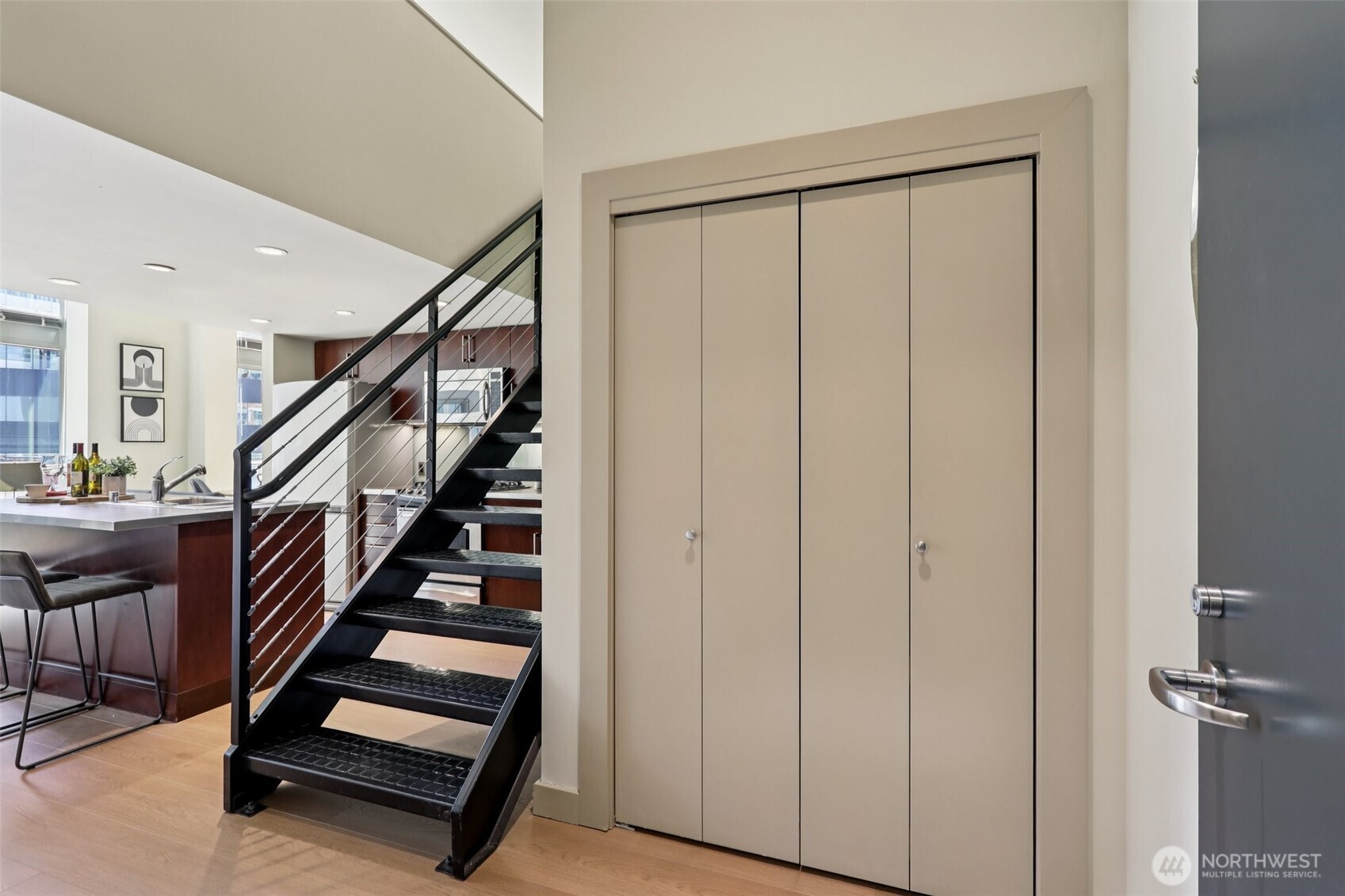 900 Lenora Street, Unit W106 Seattle, WA 98121 - Photo 7 of 40 a view of entryway with wooden floor and stairs