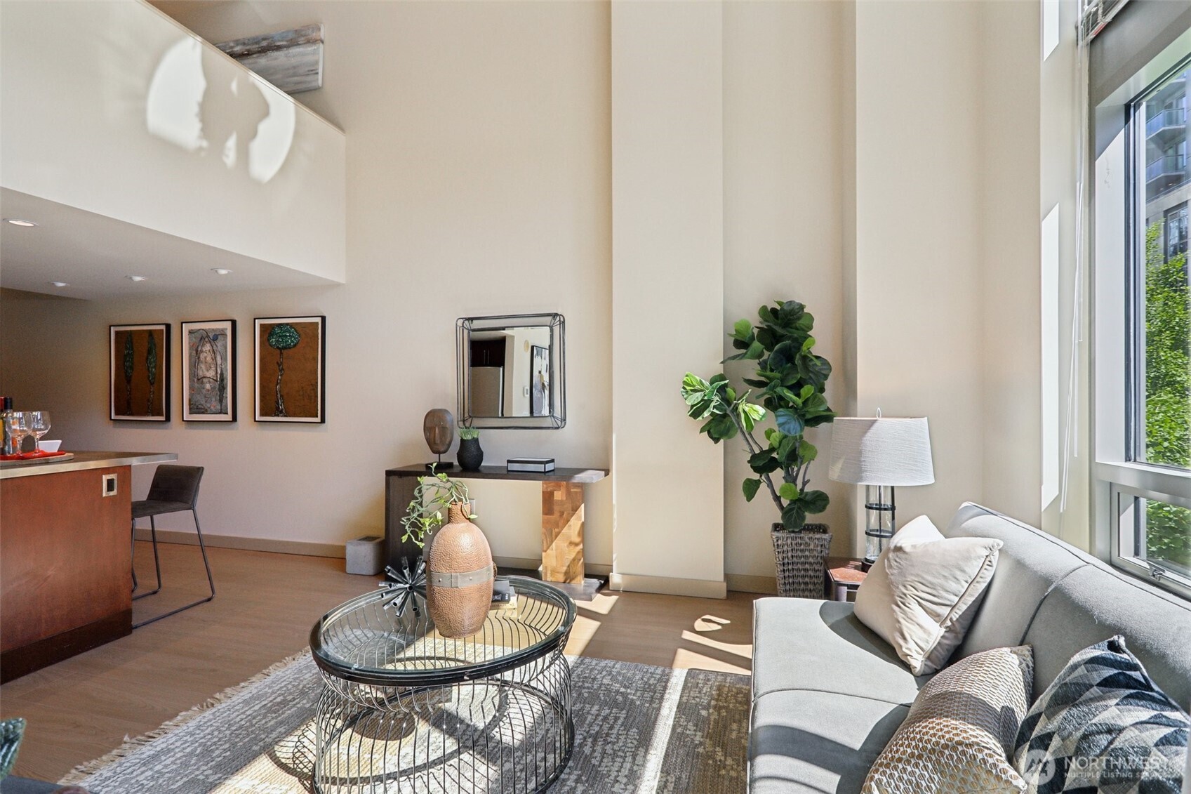 900 Lenora Street, Unit W106 Seattle, WA 98121 - Photo 9 of 40 a living room with furniture and a potted plant