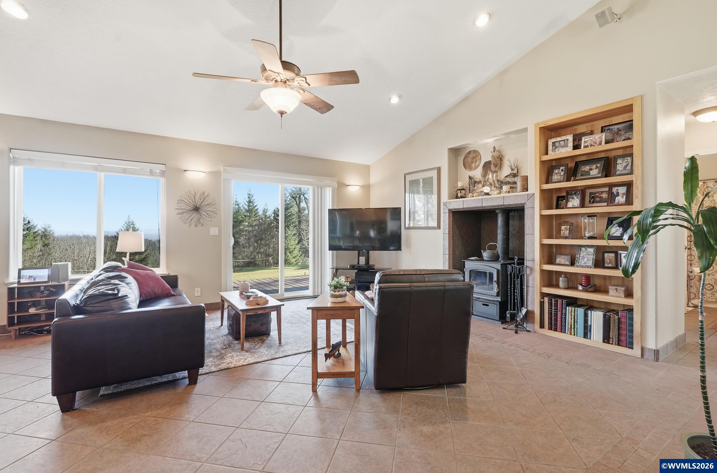 1110 Reuben Boise Road Dallas, OR 97338 - Photo 9 of 49 a living room with furniture a flat screen tv and a bookshelf