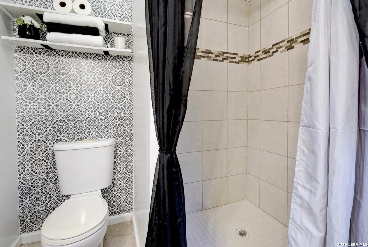 309 South Rolling Oaks Lane San Antonio, TX 78253 - Photo 20 of 43 a white toilet sitting next to a bathroom sink