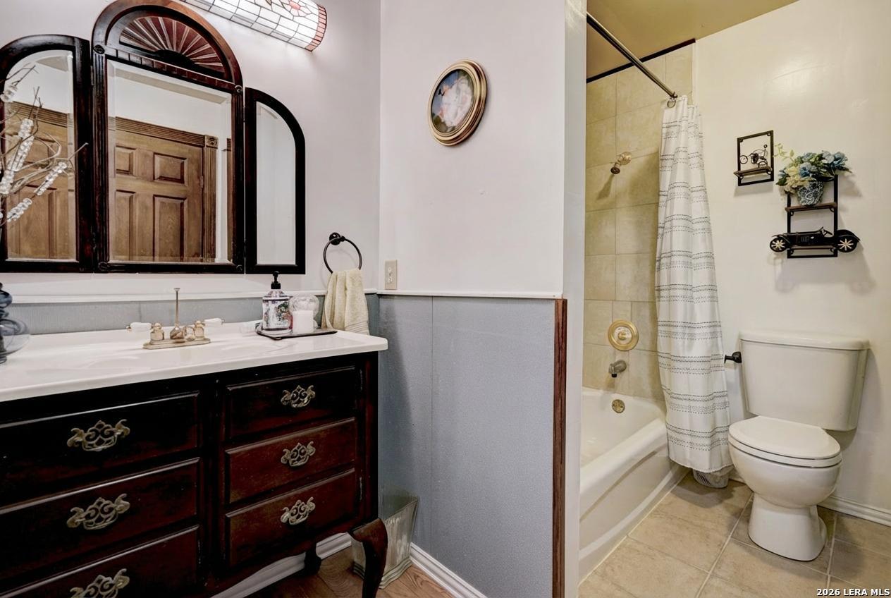 309 South Rolling Oaks Lane San Antonio, TX 78253 - Photo 29 of 43 a bathroom with a toilet sink double vanity and mirror