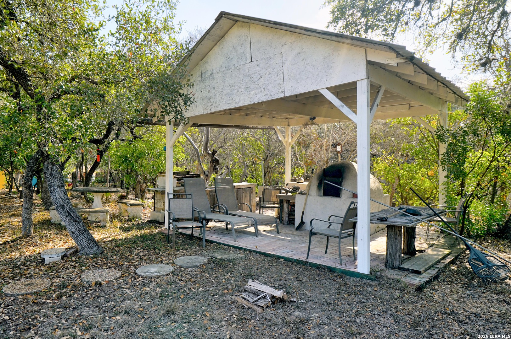 309 South Rolling Oaks Lane San Antonio, TX 78253 - Photo 37 of 43 a view of a patio with a table and chairs under an umbrella