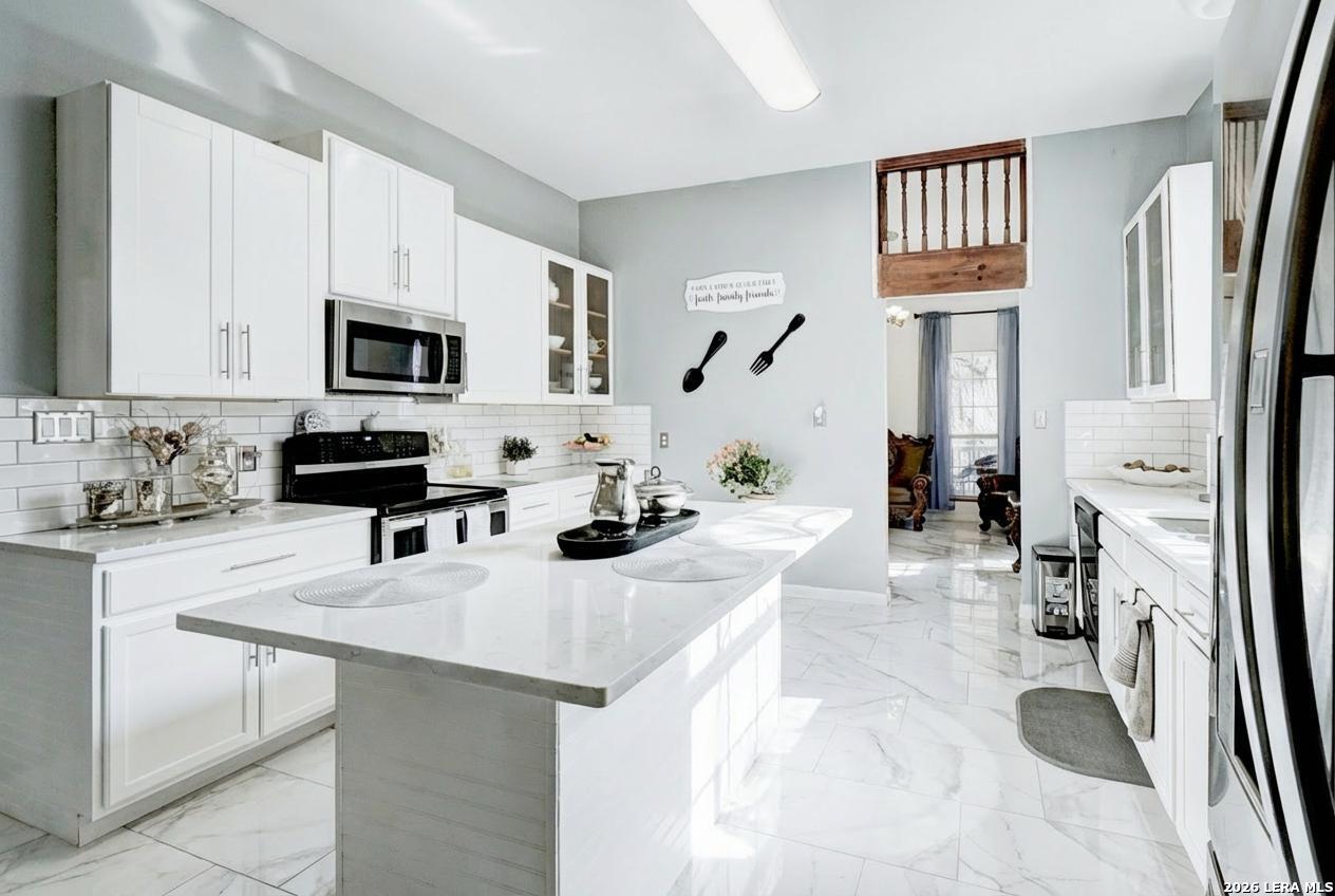 309 South Rolling Oaks Lane San Antonio, TX 78253 - Photo 10 of 43 a kitchen with stainless steel appliances a stove a sink a microwave a refrigerator and cabinets