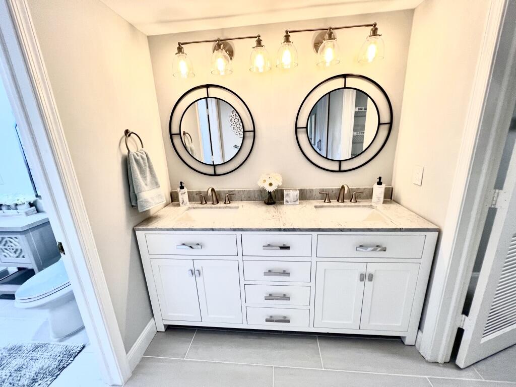17081 Waterbend Drive, Unit 229 Jupiter, FL 33477 - Photo 12 of 26 a bathroom with a sink a vanity and a mirror