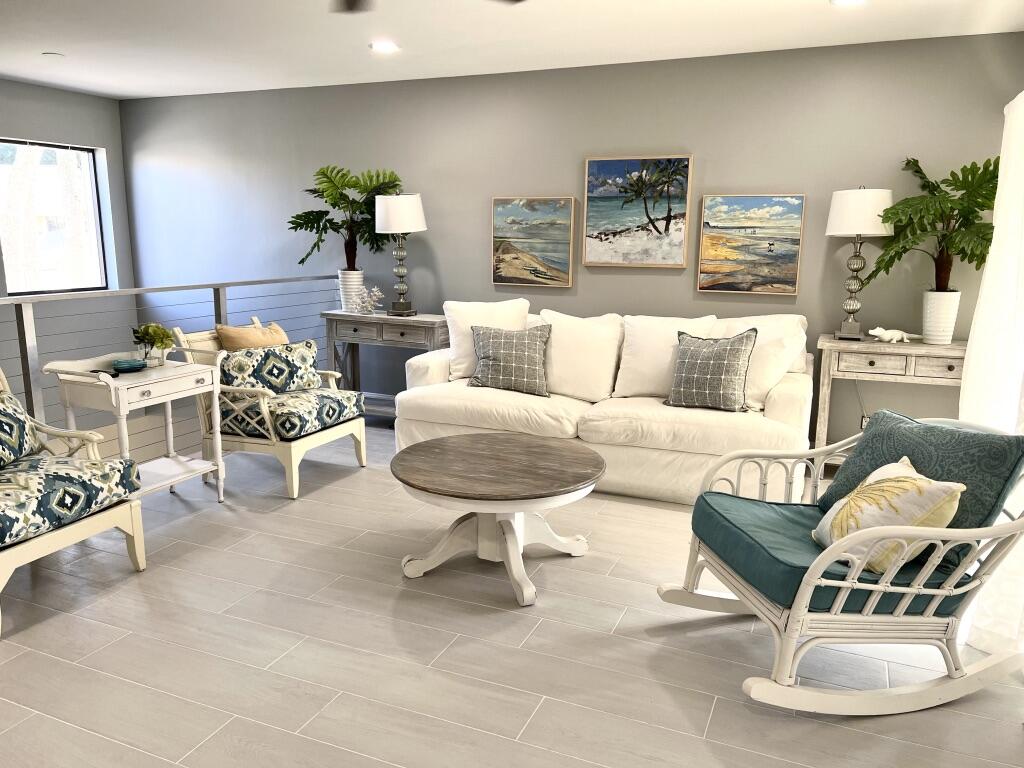 17081 Waterbend Drive, Unit 229 Jupiter, FL 33477 - Photo 14 of 26 a living room with furniture and a chandelier