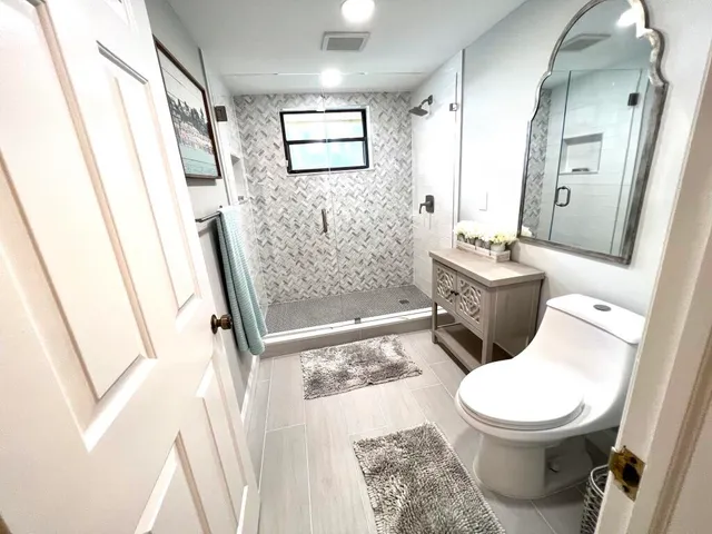 a bathroom with a toilet and a shower