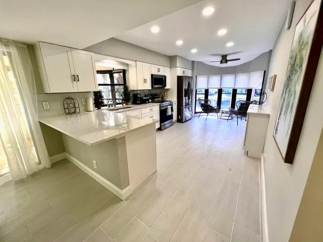 a large white kitchen with lots of counter top space