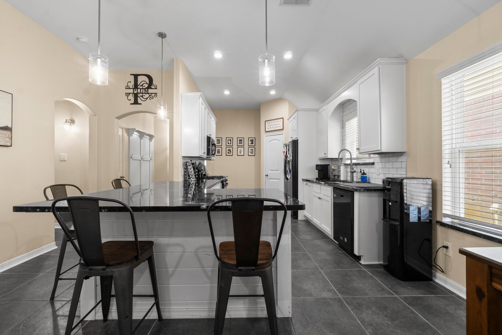 28987 Birch Green Way Spring, TX 77386 - Photo 3 of 32 a kitchen with stainless steel appliances kitchen island granite countertop a dining table chairs and a refrigerator