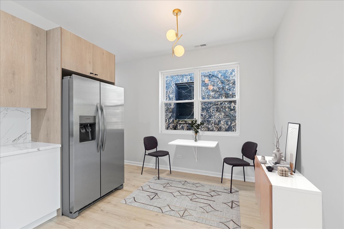 4537 South Evans Avenue, Unit 2 Chicago, IL 60653 - Photo 4 of 12 a living room with furniture a window and a dining table with wooden floor