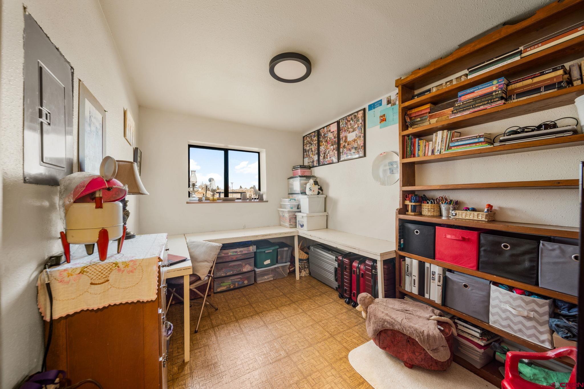 25220 County Rd M Cortez, CO 81321 - Photo 25 of 45 a room with furniture and a book shelf