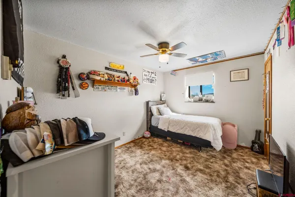 a bedroom with furniture and a flat screen tv
