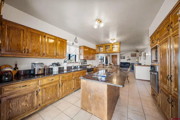 a kitchen with stainless steel appliances granite countertop a sink and cabinets