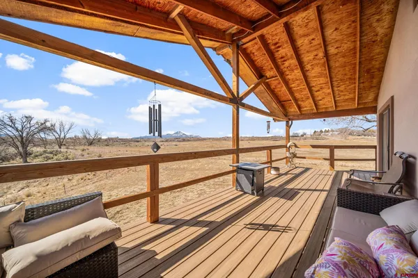 a view of balcony with couch and wooden floor