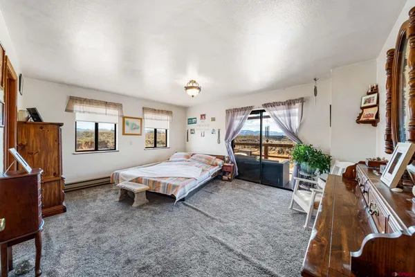 a bedroom with bed and glass door