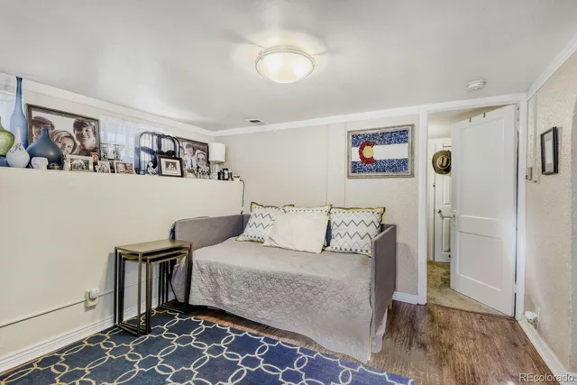 a living room with furniture and a book shelf