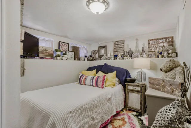 a bedroom with a bed and flat screen tv