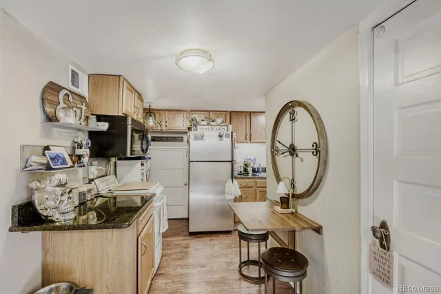 a room with furniture a mirror and white walls