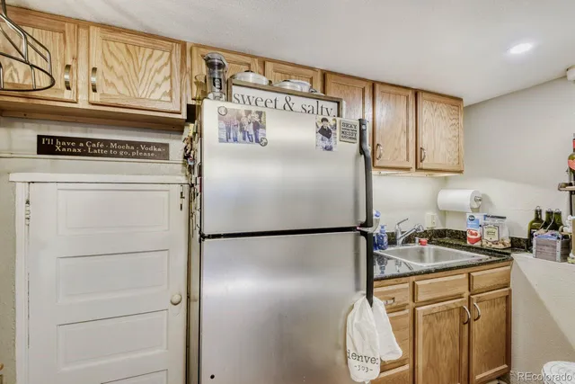 a kitchen with refrigerator and cabinets