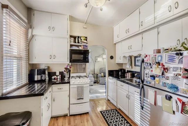 a kitchen with stainless steel appliances a sink a stove and cabinets