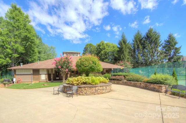 a view of a house with a yard and potted plants