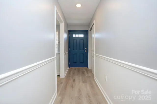 a view of hallway with wooden floor