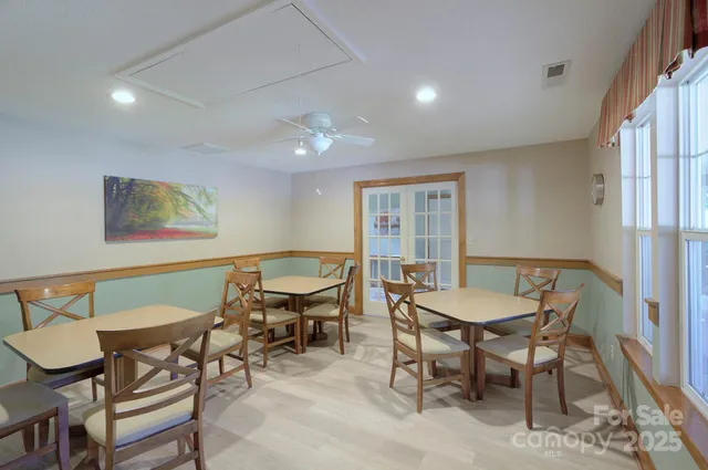 a view of a dining room with furniture a rug and wooden floor