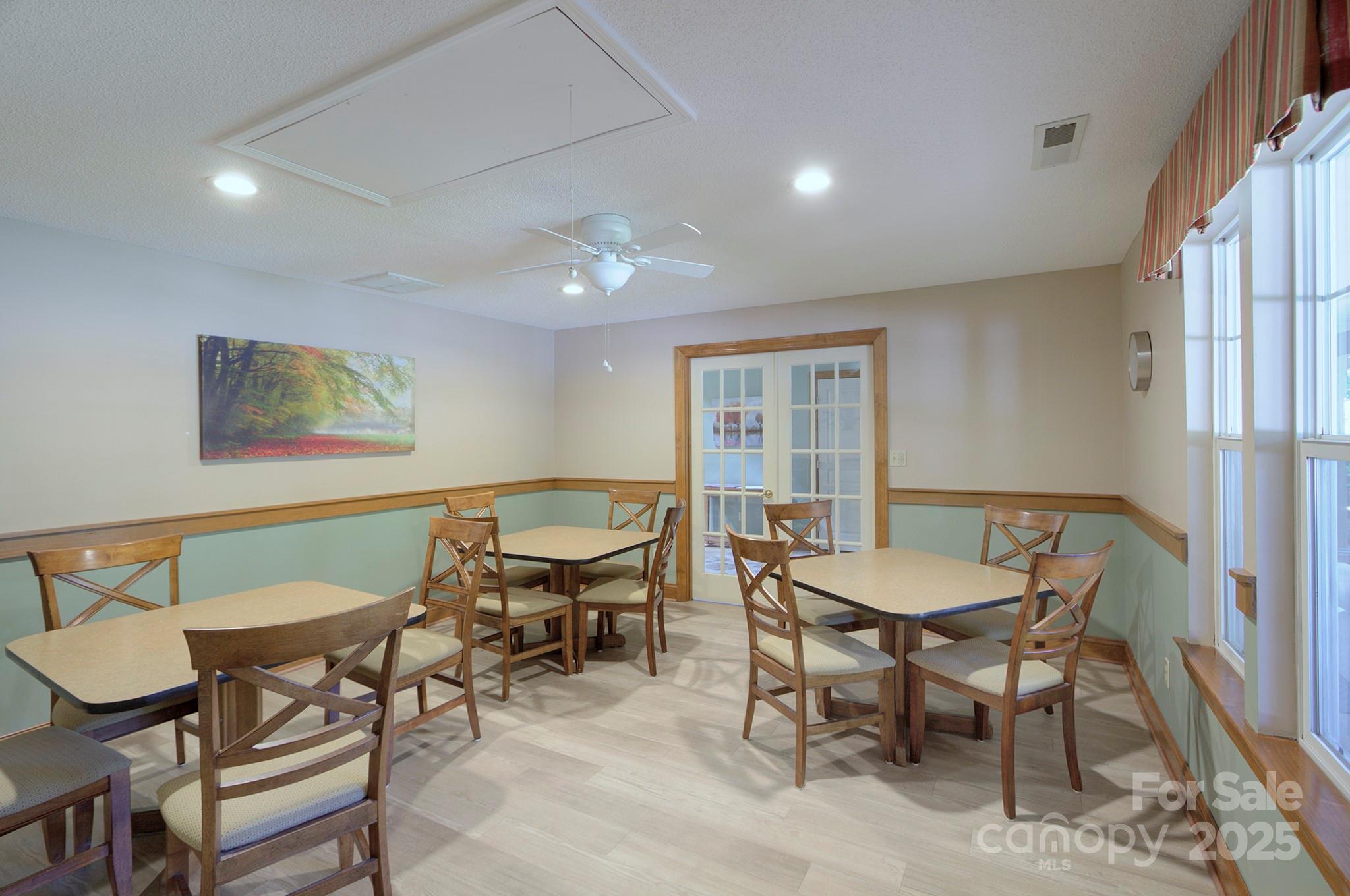 1104 Deermouse Way Hendersonville, NC 28792 - Photo 31 of 32 a view of a dining room with furniture a rug and wooden floor