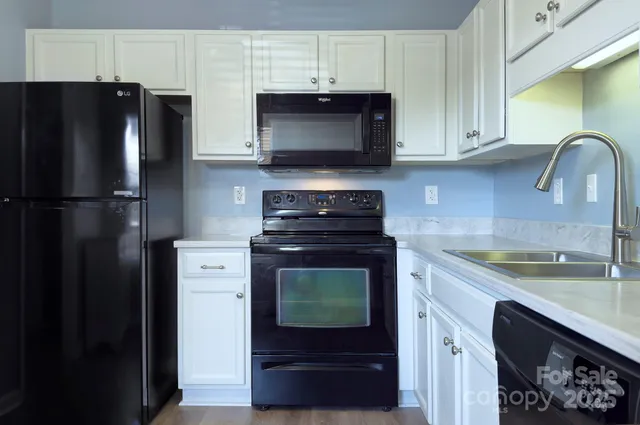 a kitchen with a refrigerator stove and microwave